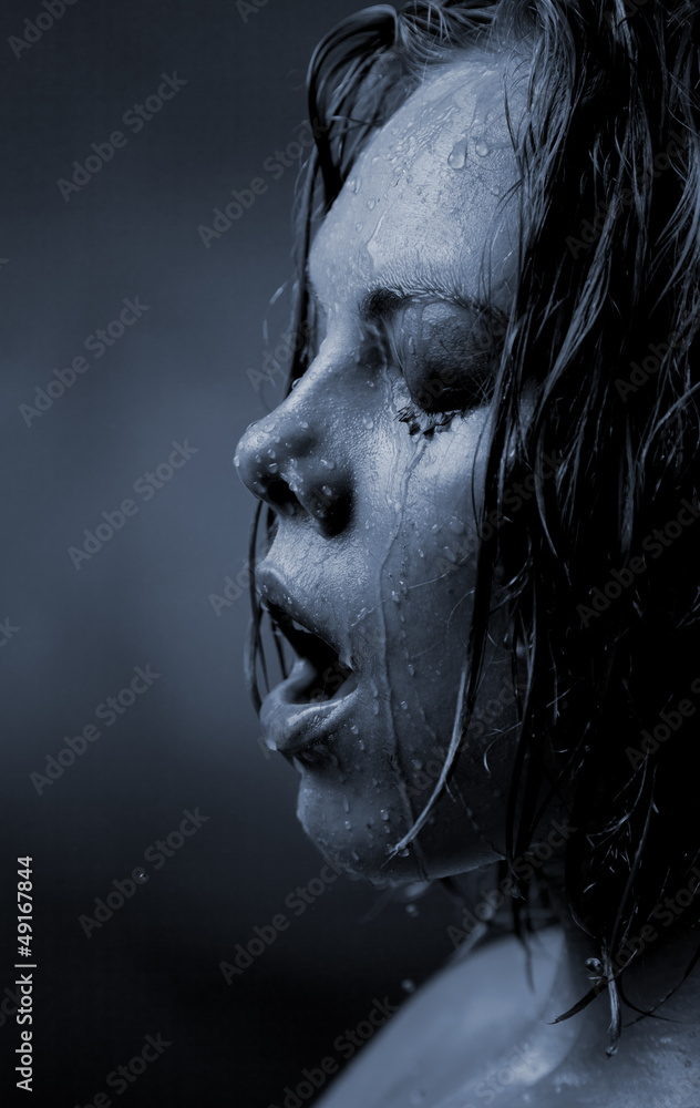 Portrait of a girl's face which water flows