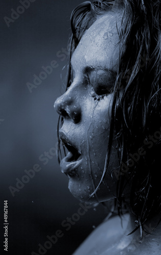 Portrait of a girl's face which water flows