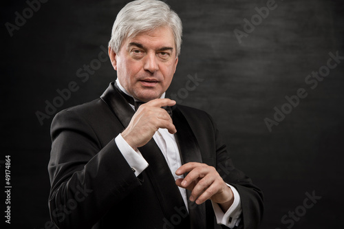 Portrait of professional hypnotist on black background © Milles Studio