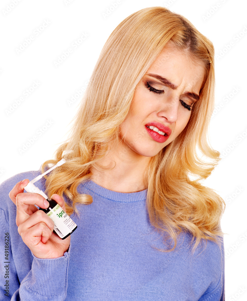 Young woman using throat spray. Young woman using throat spray.