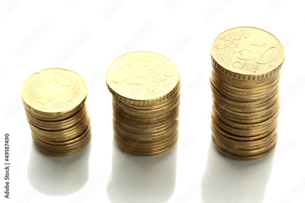 Many coins in columns isolated on white Many coins in columns isolated on white