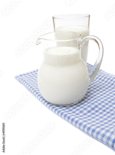 A Glass of milk on plaid towel, isolated on the white.A Glass of