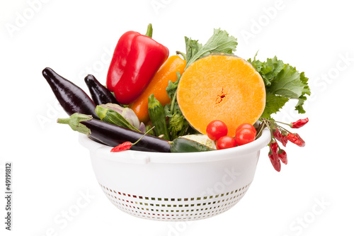 Colander With Vegetables On White