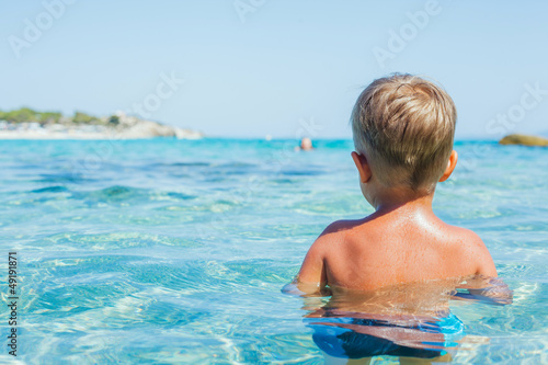 Young boy swimming in sea photo