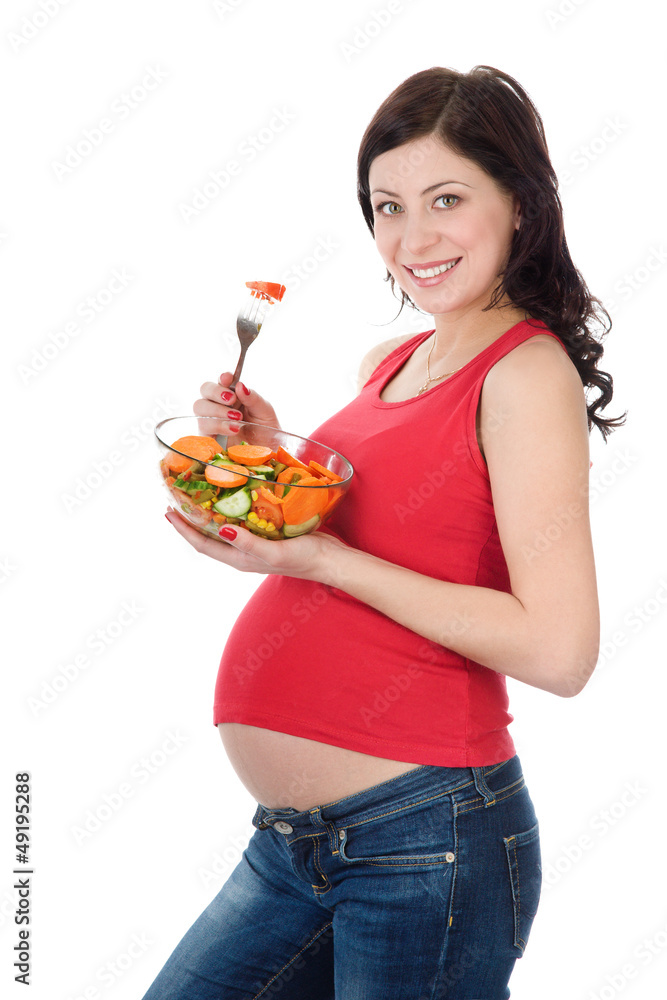pregnant woman eating salad. isolated on white pregnant woman eating salad. isolated on white