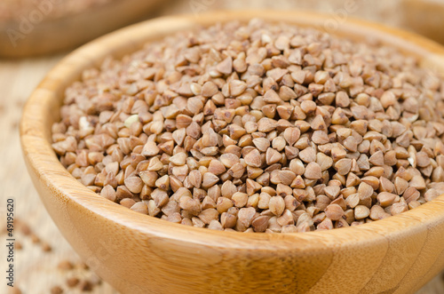 Buckwheat in a wooden bowl horizontal closeup