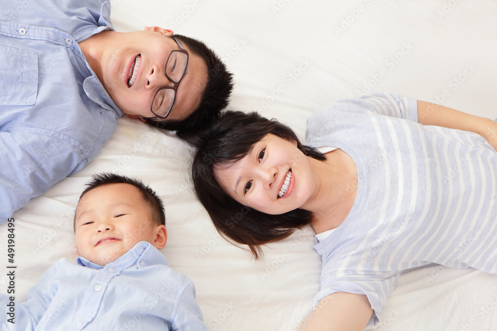 Happy family with children in bed