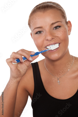 Happy woman cleaning her teeth