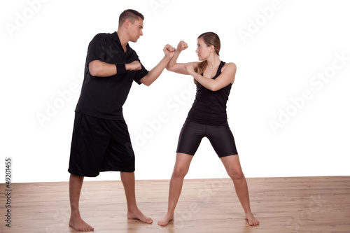 Young woman practising kick boxing