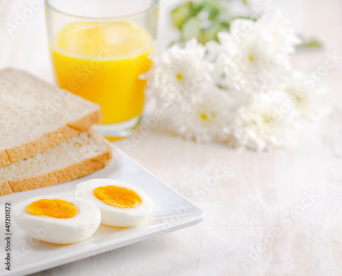 Boiled egg  toasts and orange juice.