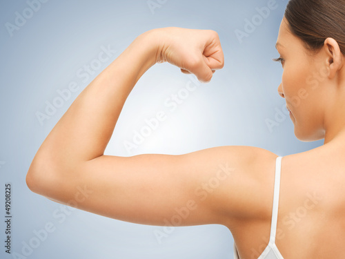 sporty woman flexing her biceps