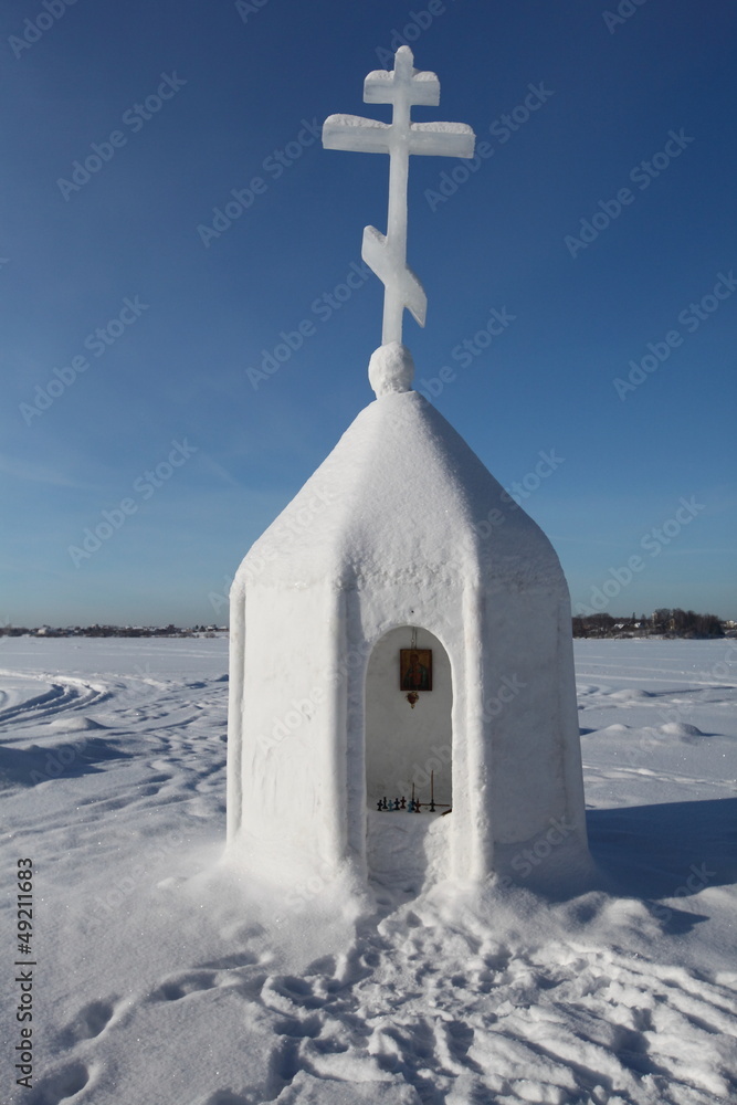 snow sculpture of church with the cross