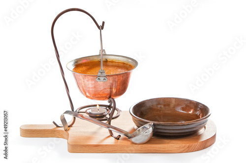 Goulash soup in a pot with ladle and plate