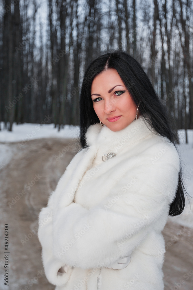 Young brunette woman in white fur coat Young brunette woman in white fur coat