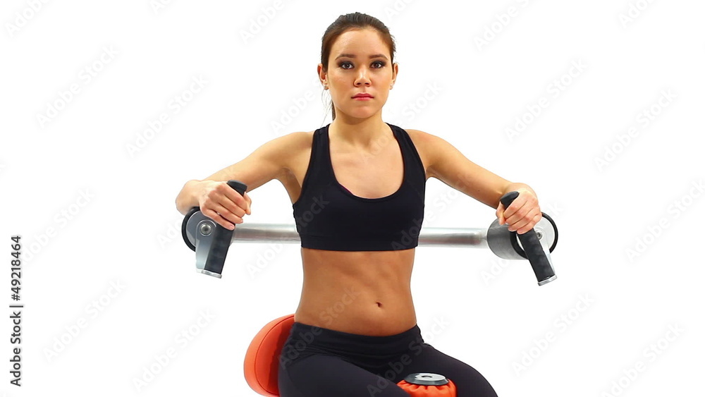 Brunette woman on hydraulic exerciser Brunette woman on hydraulic exerciser