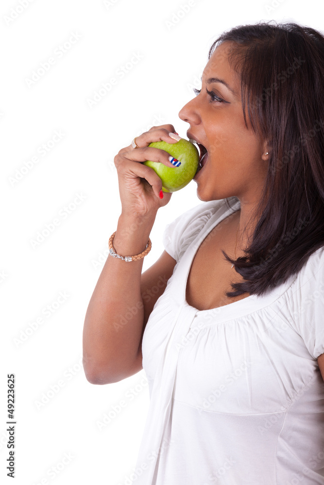 Young indian woman eating an apple Young indian woman eating an apple