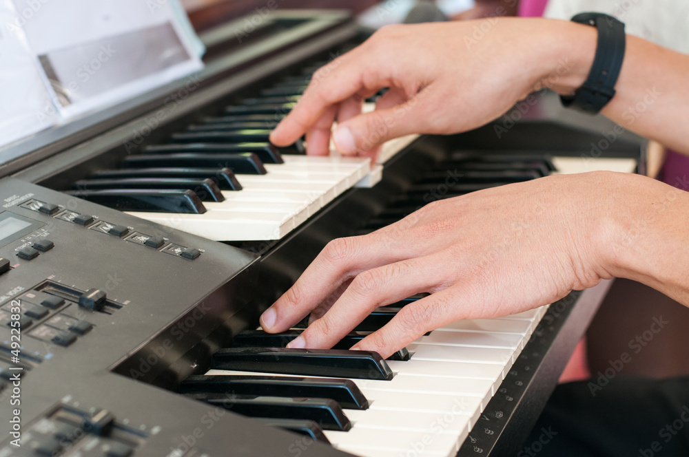 Fototapeta premium Male hands playing the piano