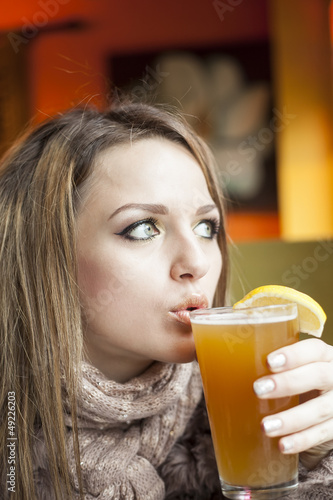 Young Woman with Beautiful Blue Eyes Drinking Hefeweizen Beer