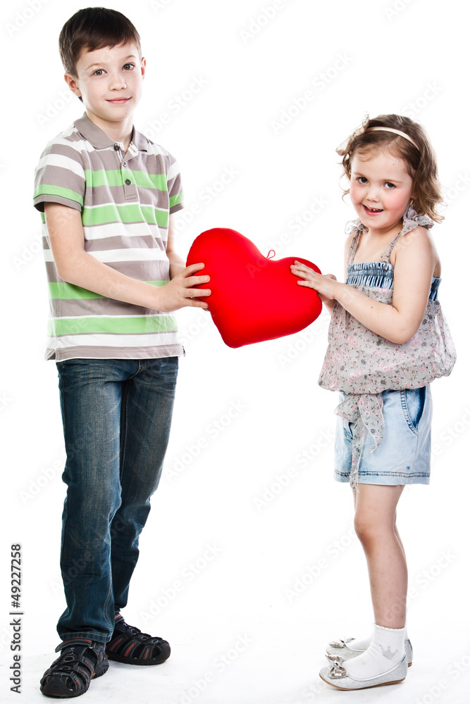 little boy gives a girl a plush heart