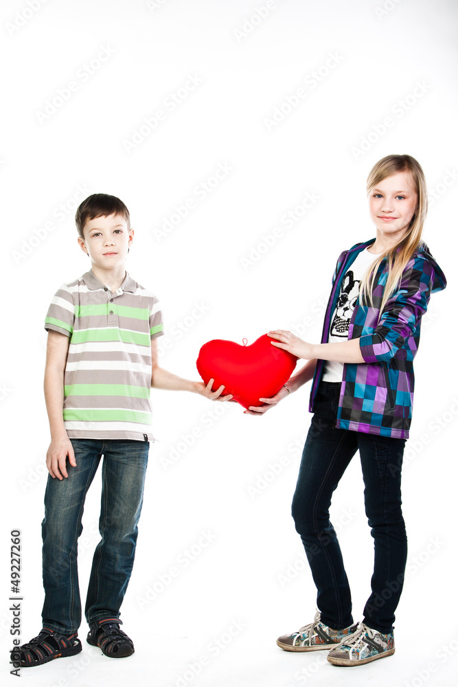little boy gives a girl a plush heart little boy gives a girl a plush heart