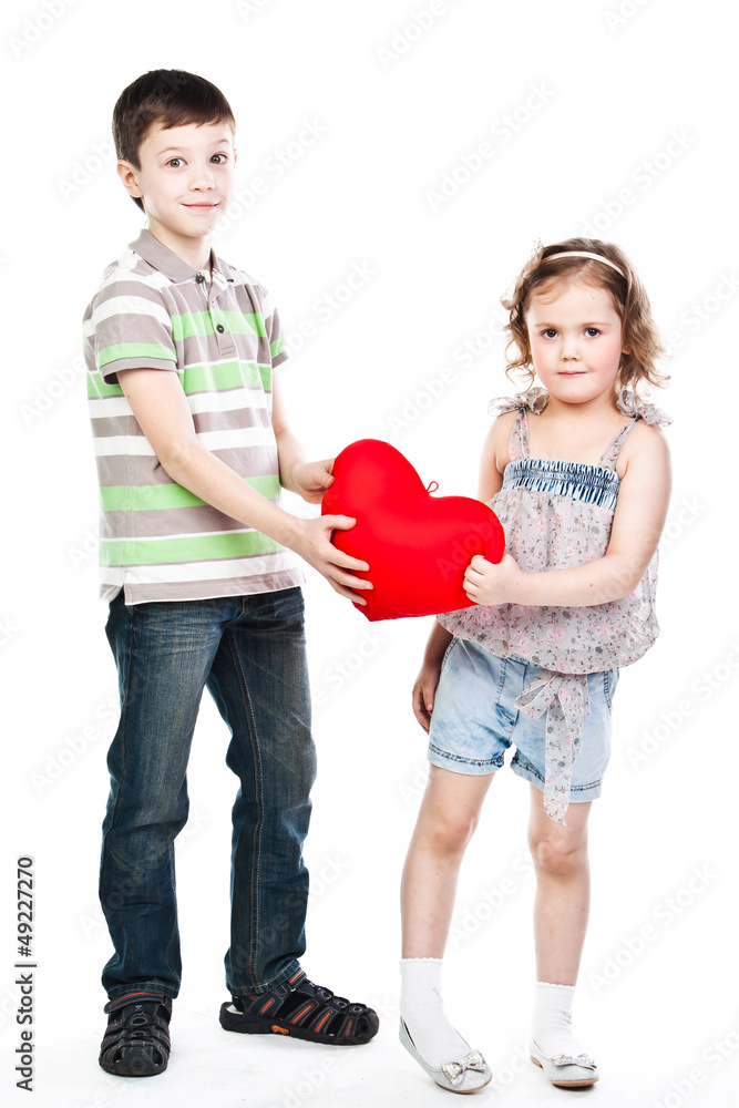 little boy gives a girl a plush heart