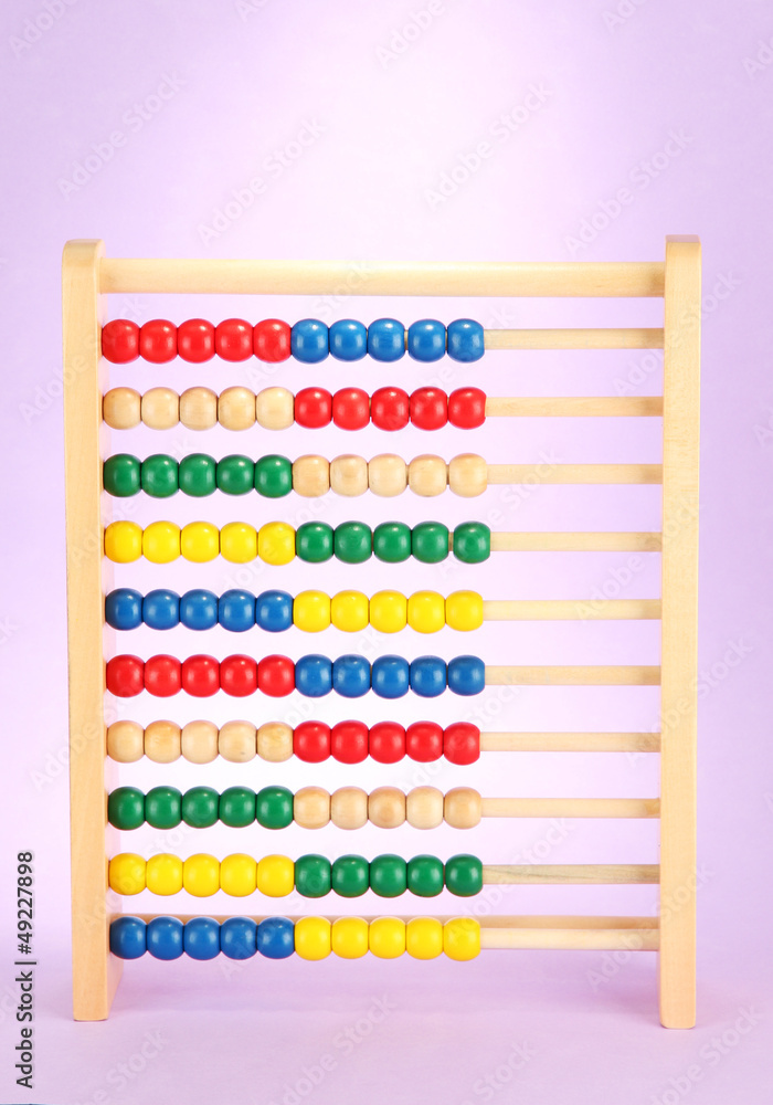 Bright wooden toy abacus, on purple background Bright wooden toy abacus, on purple background