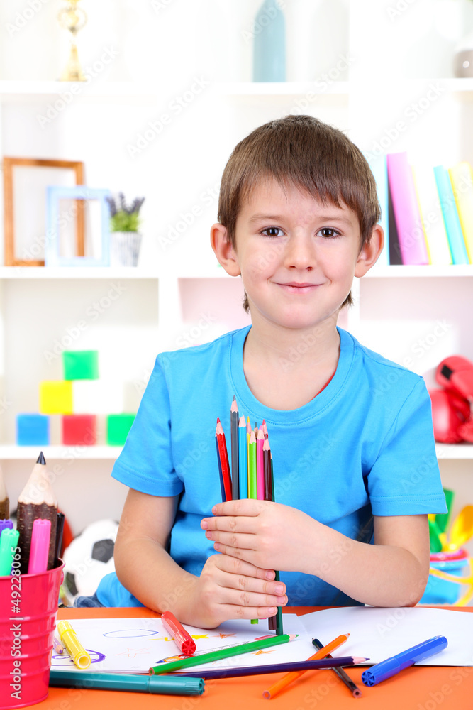 Cute little boy drawing in his album Cute little boy drawing in his album