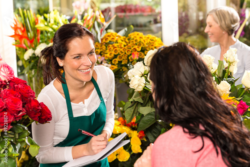 Obraz na płótnie Happy florist writing flower shop talking customer w salonie