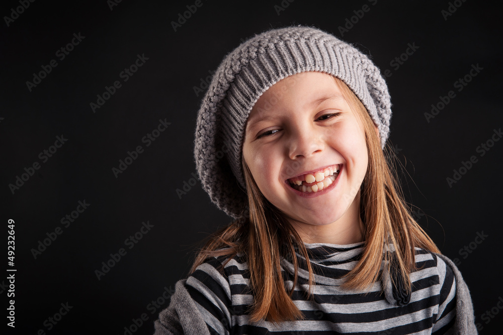 Laughing young girl close up portrait on black background. Laughing young girl close up portrait on black background.