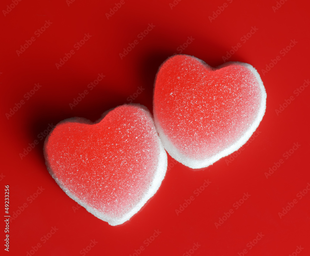 Sugar hearts on red background
