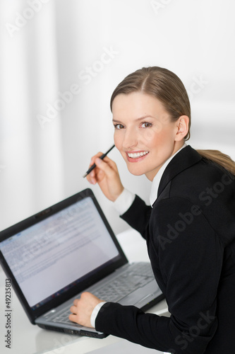 Business woman showing blank laptop screen ready for text