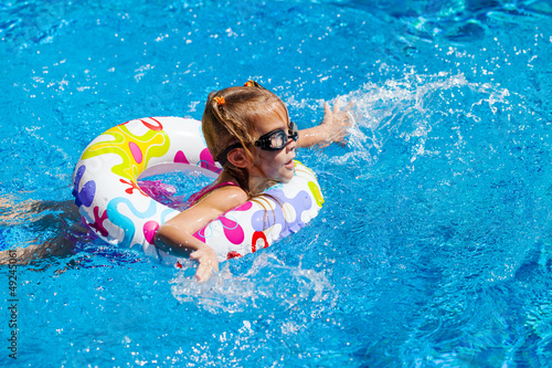 little girl in the pool with rubber ring
