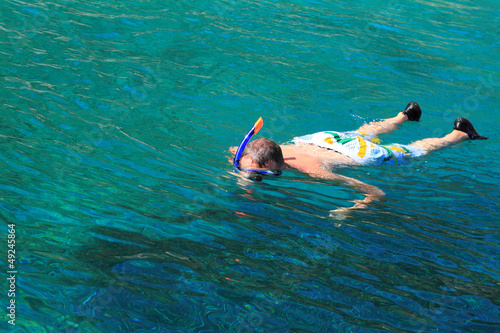 Young man is snorkeling