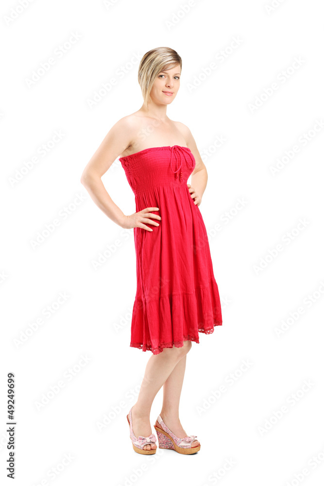Full length portrait of a young woman posing in a red dress Full length portrait of a young woman posing in a red dress