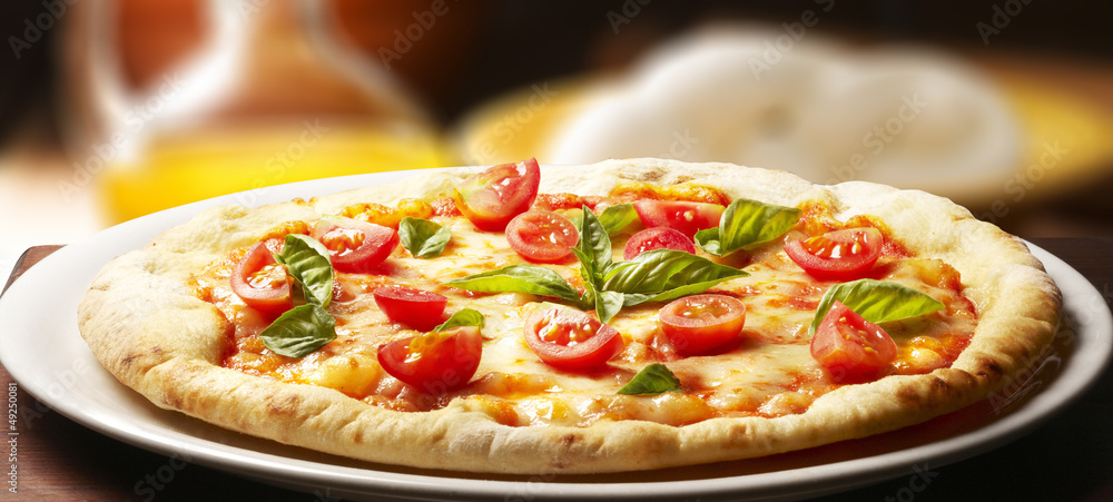 pizza with ingredients on wooden table