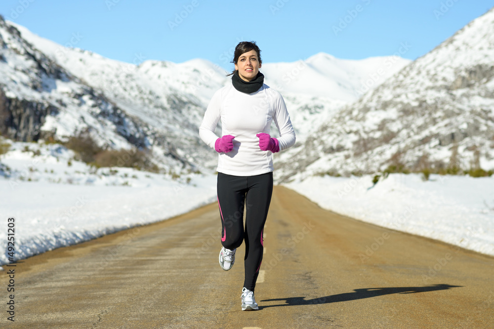 Woman running on winter road