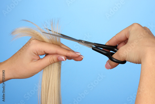 Hair cutting, hair stylist at work with scissors