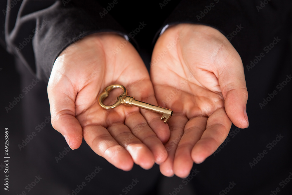 Brass key in cupped male hands