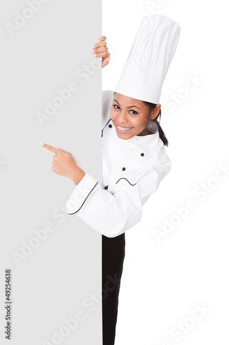 Female Cook Standing Behind The Placard