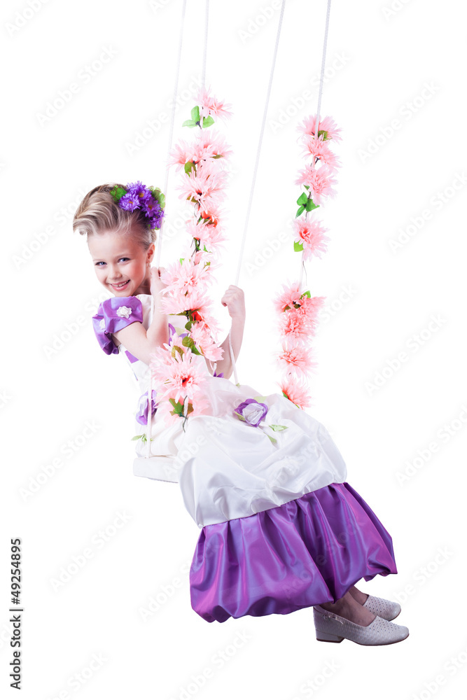 Beautiful child on floral swing isolated