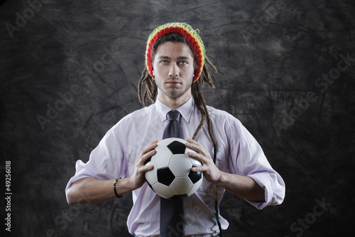 Young businessman with a soccer ball