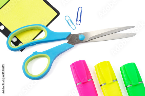 Scissor, Paper Clip, Stikers and Three Highlighter Pens on White