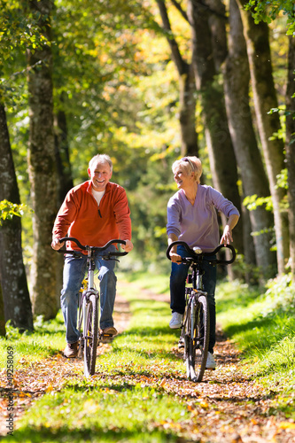 Seniors exercising with bicycle photo