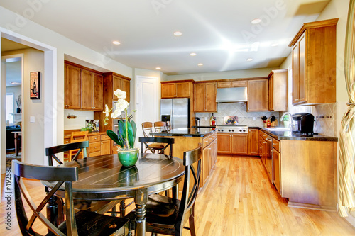 Wood classic large kitchen with granite island.