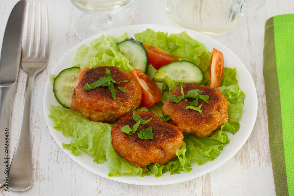 meatballs with salad on the white plate