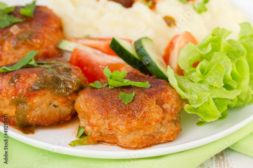 fried meatballs with mashed potato, sauce and salad