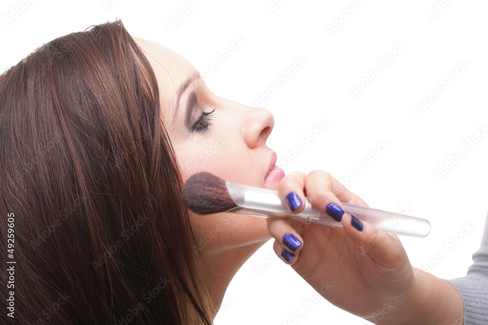 beautiful young brunette woman applying powder with a brush beautiful young brunette woman applying powder with a brush