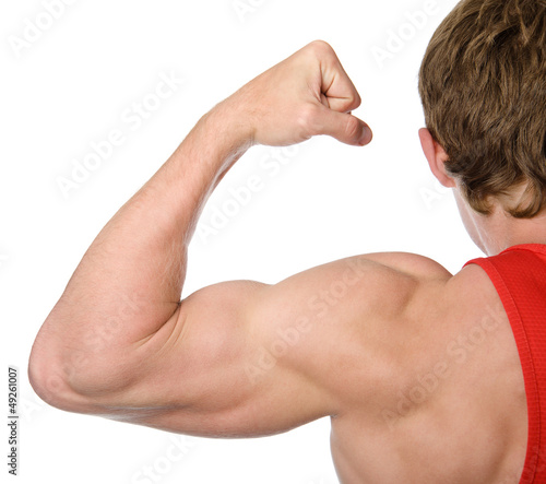 The athlete shows his powerful arm and shoulder
