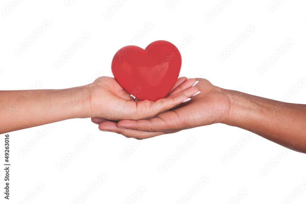 african Man and woman holding red heart in hands isolated on whi