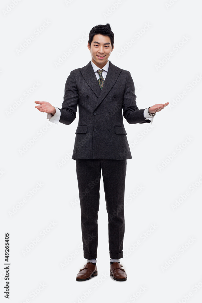 Young Asian business man showing welcom sign. Young Asian business man showing welcom sign.